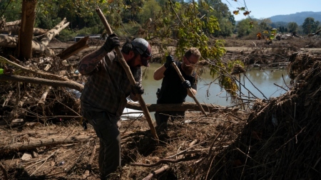 Bailey Stone with the United Cajun Navy (L) and a volunteer dig after a body was located under rubble in the aftermath of Hurricane Helene in Burnsville, North Carolina, on Oct. 5, 2024.