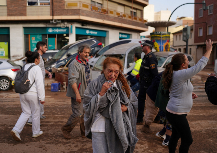 A woman reacts in a street covered in mud following deadly floods in Valencia's De La Torre neighborhood, eastern Spain, on Oct. 30, 2024. Floods triggered by torrential rains in Spain's eastern Valencia region has left at least 70 people dead, rescue services said on Oct. 30. 