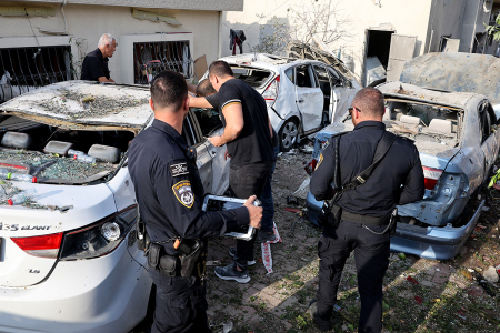 Israeli police officers and residents check the damage following a rocket attack from southern Lebanon that targeted the central Israeli-Arab city of Tira, on Nov. 2, 2024, amid the ongoing war between Israel and Hezbollah. 