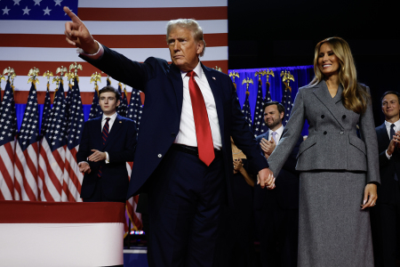 Republican presidential nominee, former U.S. President Donald Trump points to supporters with former first lady Melania Trump during an election night event at the Palm Beach Convention Center on Nov. 06, 2024, in West Palm Beach, Florida. 