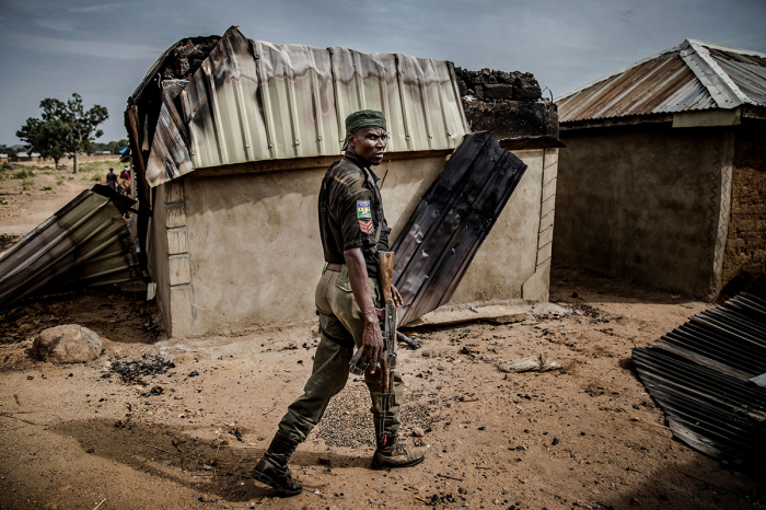 A Nigerian police officer patrols an area of destroyed and burned houses after a recent Fulani attack in the Adara farmers' village of Angwan Aku, Kaduna State, Nigeria, on April 14, 2019. The ongoing strife between Muslim herders and Christian farmers, which claimed nearly 2,000 lives in 2018 and displaced hundreds of thousands of others, is a divisive issue for Nigeria and some other countries in West Africa. 