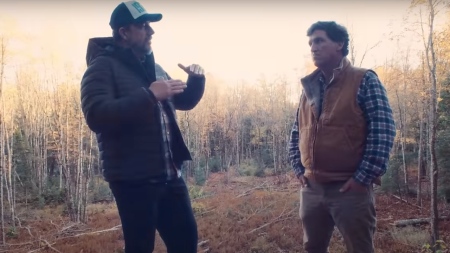 John Heers, left, speaks to Tucker Carlson, right, about the role of evil in the world and what Carlson described as a demonic attack that left him bloodied shortly before he departed Fox News in 2023.