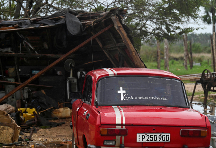 A car is pictured next to the debris of a house after the passage of hurricane Rafael in Batabano, Artemisa province, Cuba, on Nov. 7, 2024. Power was restored to parts of Cuba on Thursday a day after Hurricane Rafael swept over the island, leaving its 10 million inhabitants without electricity for the second time in a month. 