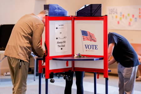 Voters cast their ballots in individual booths at a polling location in Fairfax on Nov. 5, 2024. Americans vote in the presidential election between Democratic candidate Kamala Harris and Republican candidate Donald Trump. (Photo by Ali Khaligh / Middle East Images / Middle East Images via AFP) (Photo by ALI KHALIGH/Middle East Images/AFP via Getty Images)