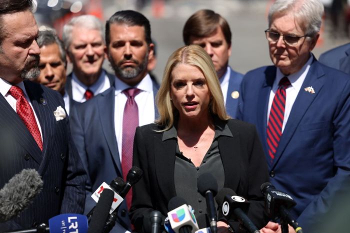 Former Attorney General of Florida Pam Bondi, flanked by Donald Trump Jr (4th L) and Texas Lt. Gov. Dan Patrick (R), speaks to the press outside of the courthouse during former President Donald Trump's trial for allegedly covering up hush money payments linked to extramarital affairs, in New York City, on May 21, 2024.