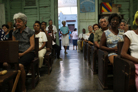 Parishioners attend a Catholic church service held in a dilapidated wooden church called Cristo Rey in a poor Santiago suburb on March 24, 2012, in Santiago de Cuba, Cuba. The government of Cuba, which officially subscribes to the Marxist ideology, has a complex relationship with the Roman Catholic church. (Photo by Spencer Platt/Getty Images)