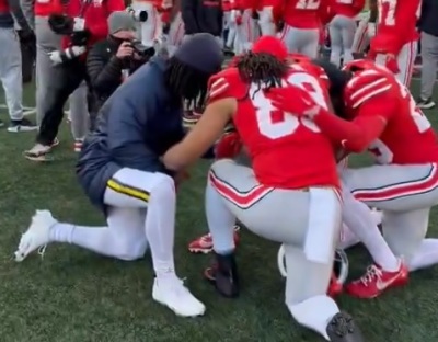 Football players for Ohio State University and the University of Michigan huddle in prayer following their game on Nov. 30, 2024 in Columbus, Ohio. 