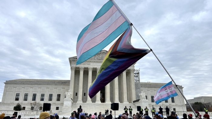 A transgender and Progress Pride flag fly outside the U.S. Supreme Court building on Dec. 4, 2024, in Washington, D.C.