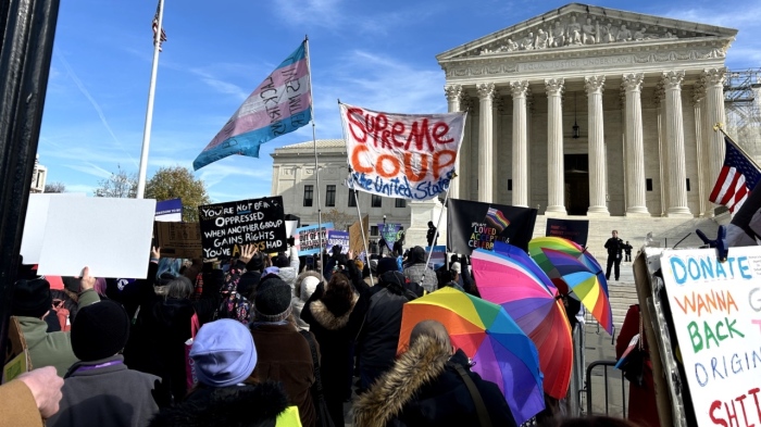 Protesters demonstrate outside the U.S. Supreme Court in Washington, D.C., on Dec. 4, 2024, regarding the case of United States v. Skrmetti.