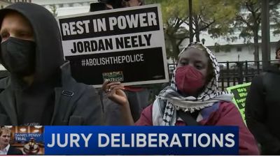 Protestors in New York City on Dec. 3, 2024, holding signs as the jury deliberates in the trial of Daniel Penny, the former Marine charged in the death of Jordan Neely. 