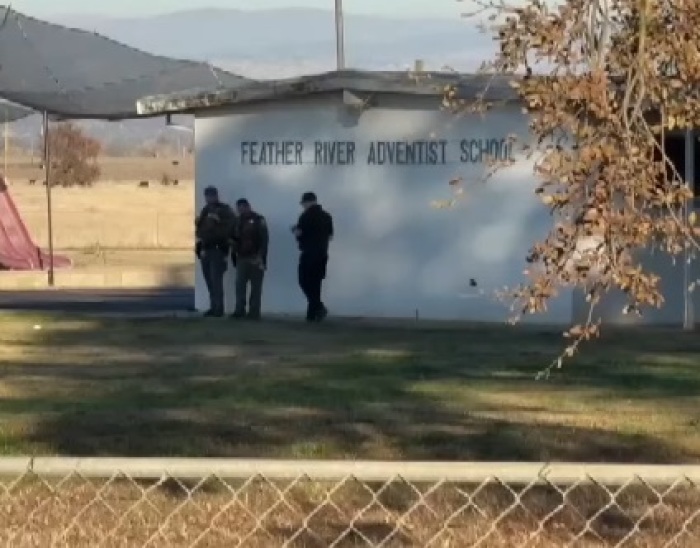 Police officers walk outside of Feather River School of Seventh-Day Adventists in Palermo, California, on Dec. 4, 2024, following a shooting that resulted in two children being wounded and the suspected shooter dying of a self-inflicted gunshot wound. 