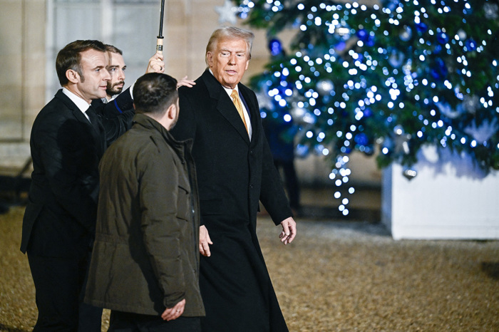 France's President Emmanuel Macron (L) walks with US President-elect Donald Trump (R) and Ukraine's President Volodymyr Zelensky (2nd R) as they leave after a meeting at The Elysee Presidential Palace in Paris on Dec. 7, 2024. Trump makes his first international trip since his election win, preparing for a day of intense diplomacy before attending the reopening ceremony for the Notre Dame cathedral restored after the April 15, 2019, fire.