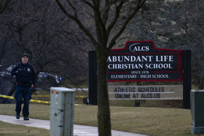 A police officer stands guard in front of the Abundant Life Christian School on December 16, 2024 in Madison, Wisconsin. According to reports, a student and teacher were shot and killed at the school earlier today, and the suspected shooter was found dead at the scene. 