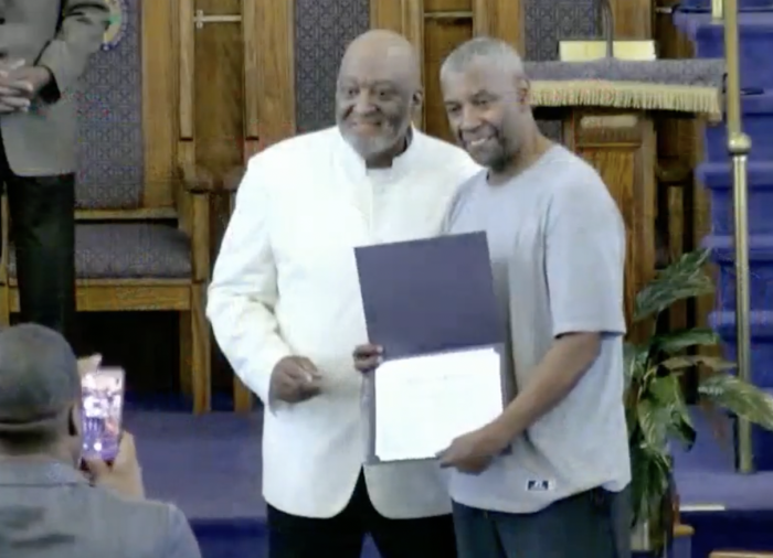 Denzel Washington receives his certificate of baptism at The First Jurisdiction Church of God in Christ.