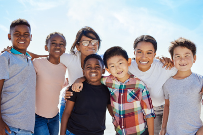 Family, adoption and kids portrait on beach with mom enjoying USA summer vacation in the sun. Foster, interracial and happy family hug together with smile on vacation break in nature.