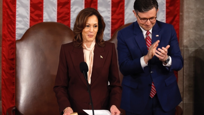 Vice President Kamala Harris certifies the Electoral College vote as US Speaker of the House Mike Johnson applauds during a joint session of Congress to ratify the 2024 presidential election at the US Capitol on Jan. 6, 2025, in Washington, DC