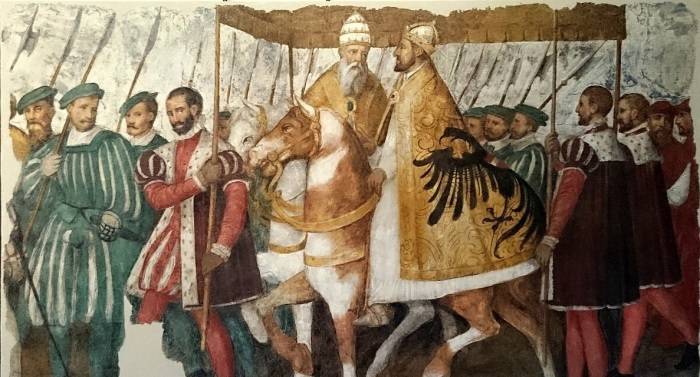 A circa 1580 depiction of Pope Clement VII and Holy Roman Emperor Charles V riding alongside each other as part of a procession. 