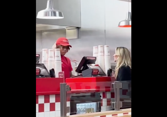 OnlyFans model Bonnie Blue speaks with an employee at a Five Guys restaurant. 