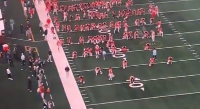 Ohio State University football players kneel down on the field before the Cotton Bowl at AT&T Stadium in Arlington, Texas, on Jan. 10, 2025. 