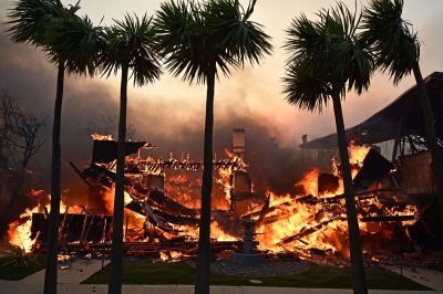 A home burns during the Palisades Fire in Pacific Palisades, California, on January 8, 2025. At least five people have been killed in wildfires rampaging around Los Angeles, officials said on January 8, with firefighters overwhelmed by the speed and ferocity of multiple blazes. 