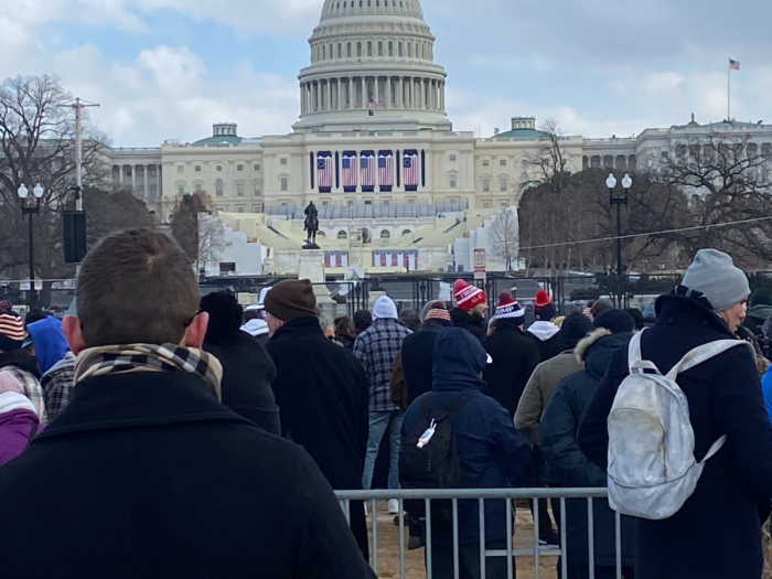 Supporters of President Donald Trump stand behind the Inauguration Platform at the United States Capitol where the 47th president of the United States would have taken the Oath of Office if not for the cold weather, Jan. 20, 2025. 