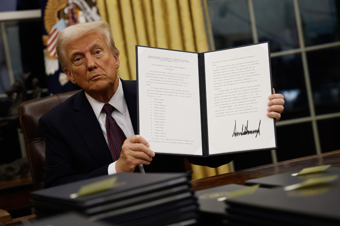 President Donald Trump signs executive orders in the Oval Office on Jan. 20, 2025, in Washington, D.C. Trump takes office for his second term as the 47th president of the United States. 