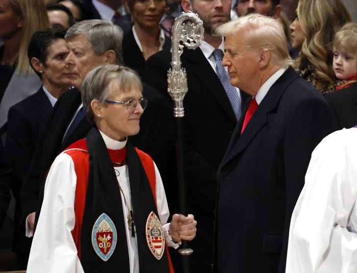 Bishop Mariann Edgar Budde (L) arrives as U.S. President Donald Trump looks on during the National Prayer Service at Washington National Cathedral on Jan. 21, 2025, in Washington, D.C. Tuesday marks Trump's first full day of his second term in the White House. 