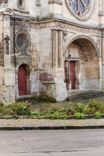 The Renaissance west facade of the Church of St. Cosmas and St. Damian in Luzarches, France. 