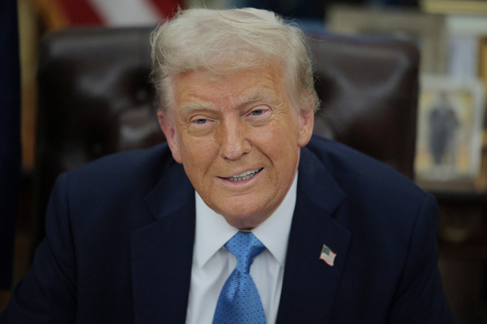 President Donald Trump talks to reporters after signing an executive order, 'Unleashing prosperity through deregulation,' in the Oval Office on Jan. 31, 2025, in Washington, D.C. Trump spoke to reporters about tariffs against China, Canada and Mexico and how the newly confirmed Interior Secretary Doug Burghum will coordinate with the Energy Department and the Environmental Protection Agency. 