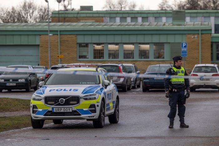 The police stand behind the barricaded area where the school shooting took place.on February 5, 2025 in Orebro, Sweden. On Tuesday a gunman opened fire in an adult education center at Risbergska School, in the Swedish city of Orebro, about 200 kilometers (124 miles) west of the capital, Stockholm. According to police, the attack left at least 11 people dead. The suspect is believed to be among the dead. 