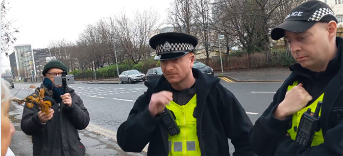 Rose Docherty, who is identified as a pro-life grandmother, is stopped from silently praying near an abortion clinic which police said is a violation of the country's “buffer zone” law. 