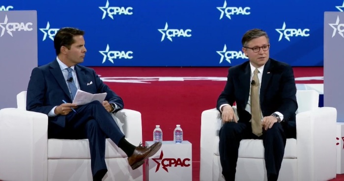 House Speaker Mike Johnson speaks with Newsmax host Rob Finnerty at the Conservative Political Action Conference in National Harbor, Maryland, on Feb. 20, 2025.