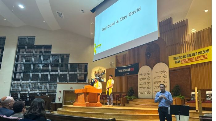 Ilay David (R) and Guy Gilboa-Dalal speak at a prayer event held at the Washington Hebrew Congregation on Feb. 18, 2025, in Washington, D.C.