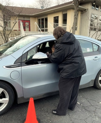 A driver receives ashes at the 'Ashes to Go' event hosted by St. Hugh of Lincoln Episcopal Church of Elgin, Illinois, on Ash Wednesday 2024. 