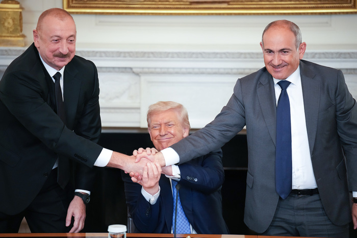 U.S. President Donald Trump (C) joins hands with Azerbaijani President Ilham Aliyev (L), and Armenian Prime Minister Nikol Pashinyan (R) during a signing ceremony in the State Dining Room of the White House on Aug. 8, 2025, in Washington, D.C. The signed agreement is intended to bring an end to the conflict between Armenia and Azerbaijan that has lasted for decades.
