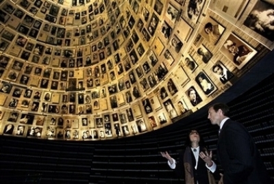 Canada's Minister of Foreign Affairs Peter MacKay, right, listens as Senior Art Curator Yehudit Shenbar gestures as they stand in the Hall of Names during a tour at Yad Vashem Holocaust Memorial in Jerusalem, Sunday, Jan. 21, 2007. MacKay is on a three day official visit to Israel and the Palestinian Territories. 