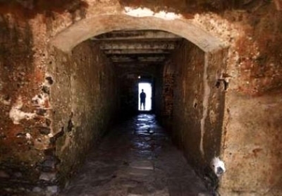 A man is silhouetted against the ''Door of No Return'' at the House of Slaves on Goree Island near Senegal's capital Dakar March 16, 2007. Millions of Africans were shipped from places like this whitewashed fort in Elmina, Ghana, to a life of slavery in Brazil, the Caribbean and America. 