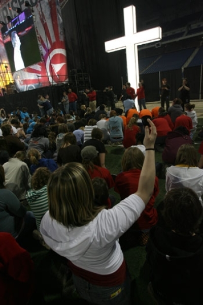 Thousands of teens kneel at the foot of a cross to commit themselves to Jesus Christ and take a stand against popular culture at BattleCry at Detroit's Ford Field, Apr. 13-14.