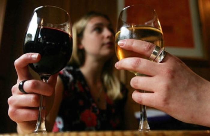 File photo dated April 25, 2007, of two females drinking wine in a central London pub.