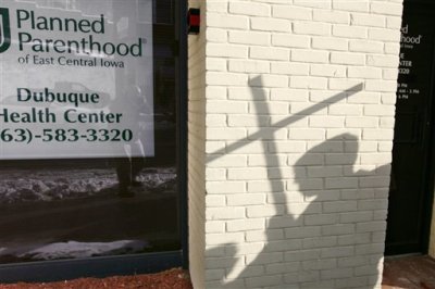 Credit : A Right To Life supporter stands near a Planned Parenthood in Dubuque, Iowa, on Jan. 22 protesting the 36th anniversary of the U.S. Supreme Court ruling in Roe v. Wade, which legalized abortions.