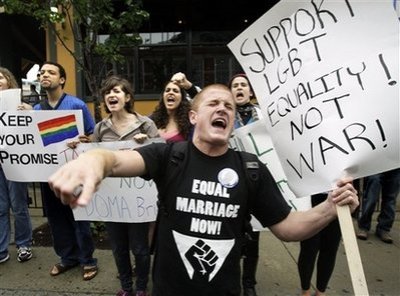 Keegan O'Brien of Worcester, Mass., leads chants as members of the LGBT (lesbian, gay, bisexual, transgender) community protest the Defense of Marriage Act outside a Democratic National Committee fundraiser at which Vice President Joe Biden was expected to attend at Fenway Park in Boston Tuesday, June 23, 2009