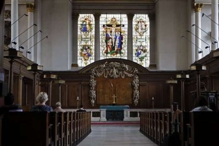 People pray inside St James's Church at Piccadilly in central London, Thursday, July 23, 2009. 