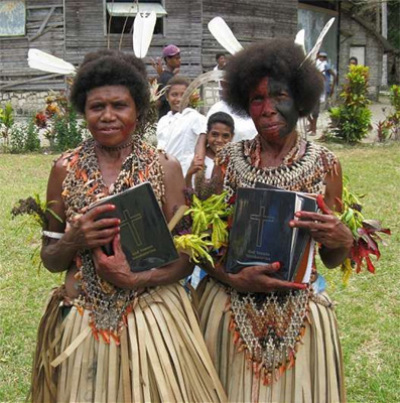 Two women with copies of the New Testament in their own language. 