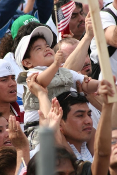 A child holds an American flag at the pro-immigration reform rally at the National Mall on Sunday, March 21, 2010 in Washington, D.C.