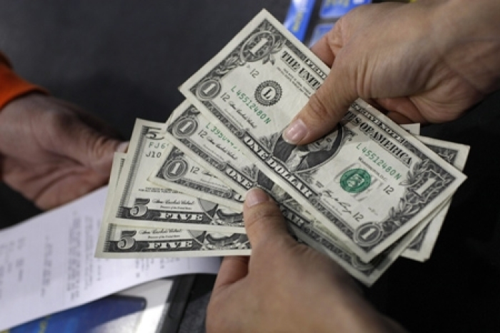 In this Oct. 7, 2009 photo, a cashier gives change to a customer at Best Buy in Mountain View, Calif.