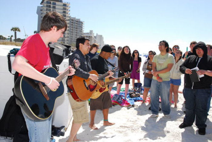 Students participating in Campus Crusade for Christ's 2010 'Big Break' outreach sing worship music on the beach.