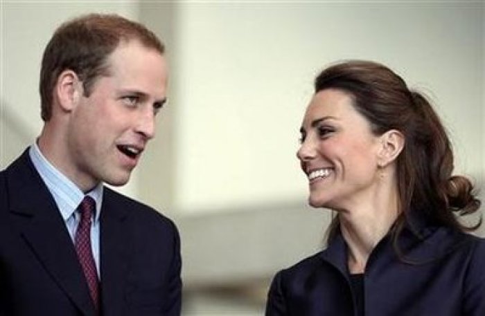 Britain's Prince William speaks, watched by his fiancee Kate Middleton at the Darwen Aldridge Community Academy, in Darwen, northern England April 11, 2011.