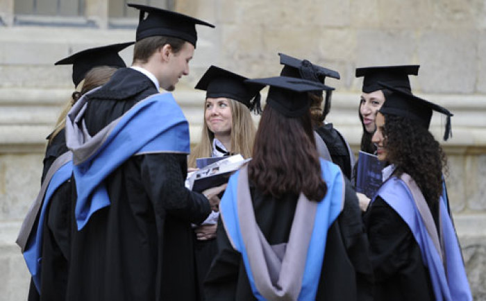 A group of graduates gather after a graduation ceremony at Oxford University, England, May 28, 2011.