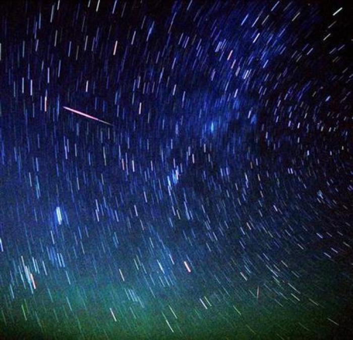 An asteroid like this is set to sail past Earth on Monday, June 27, 2011. Meteors (L, top and bottom, red) streak past stars in the night sky near Amman, in the early hours of August 12, 2005.