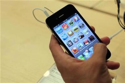 A customer looks at an iPhone 4 at the Apple Store 5th Avenue in New York, in this June 24, 2010 file photo.